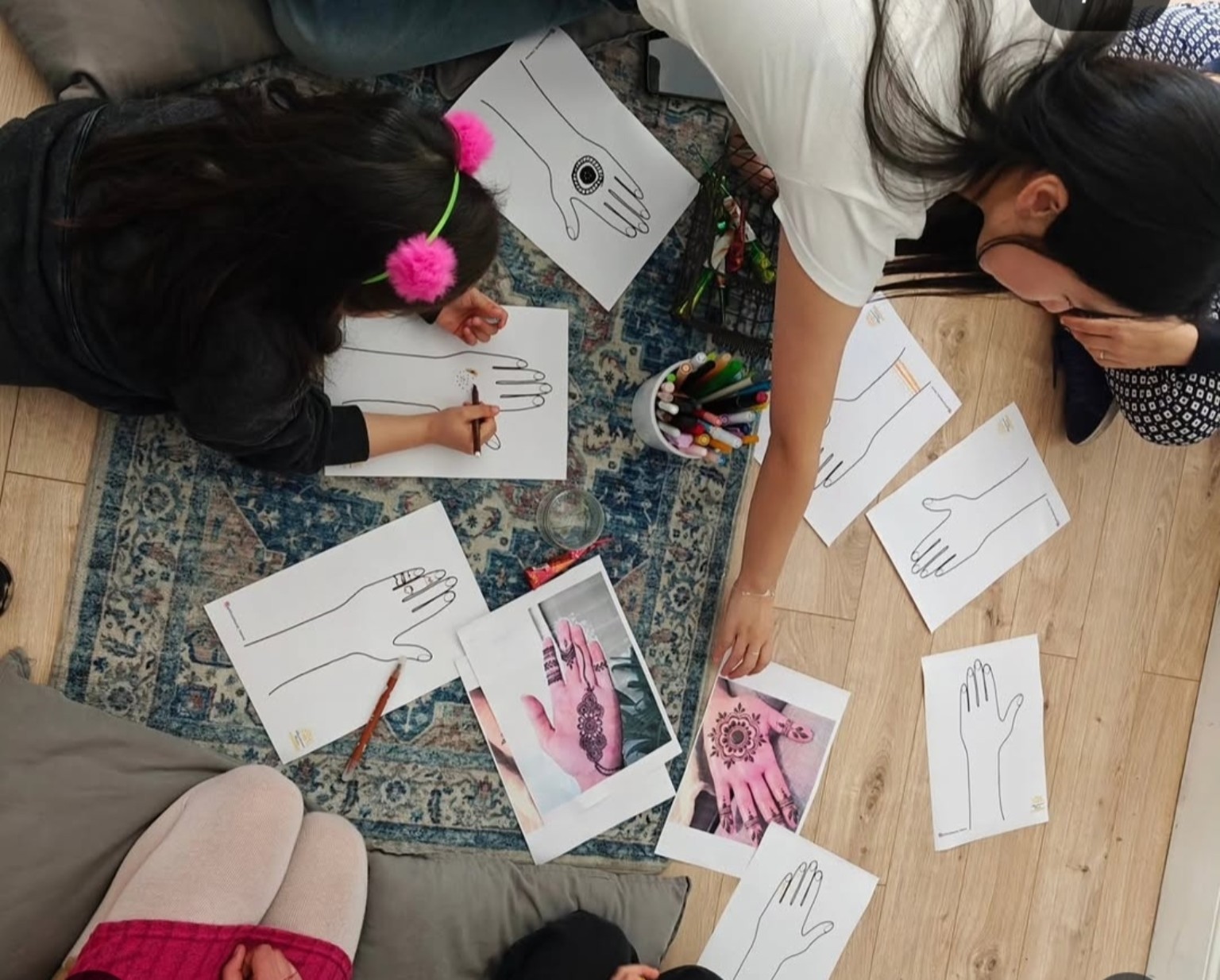 Participants creating hand-based cultural designs in a workshop