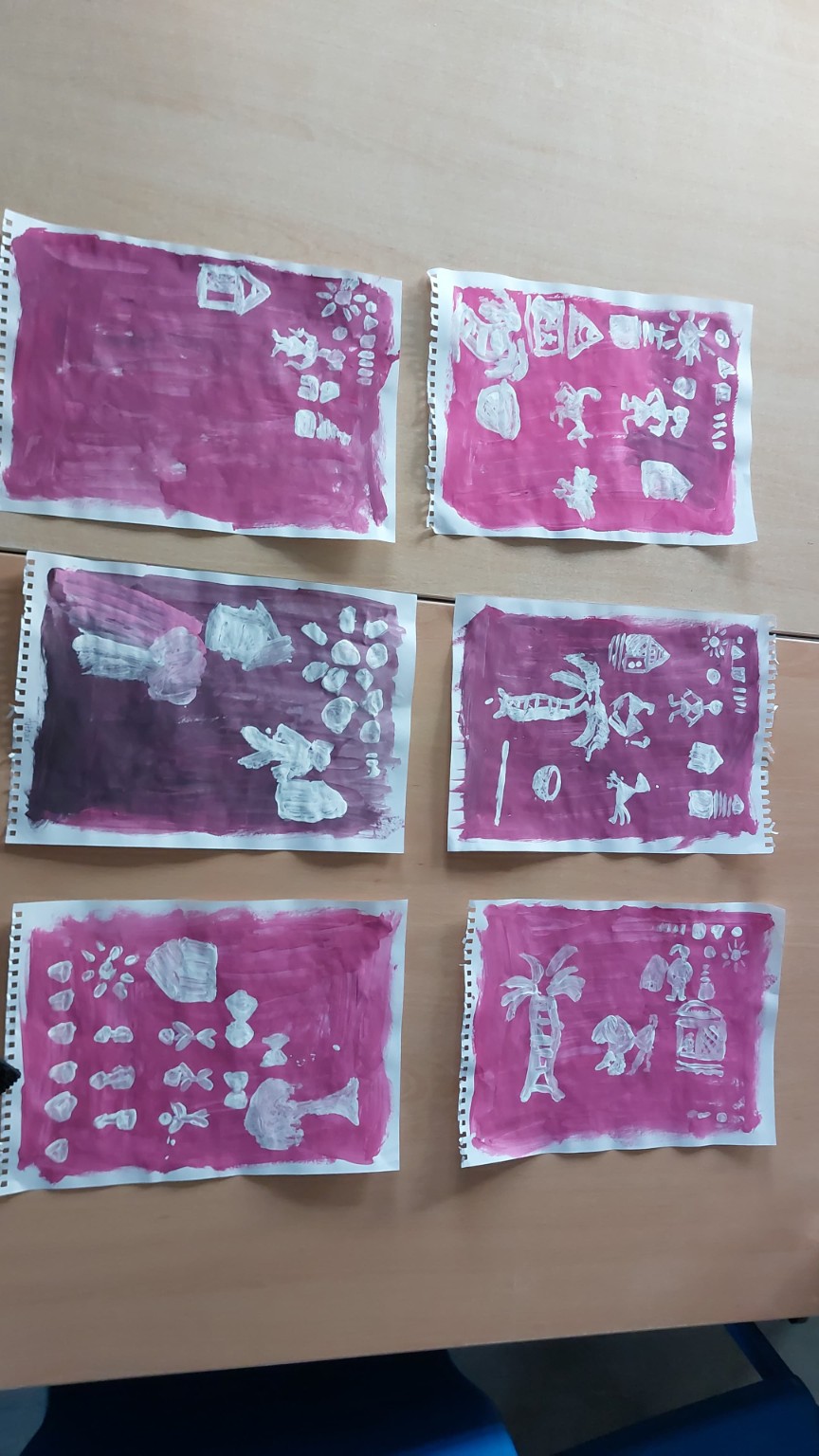 Traditional art workshop papers displayed on a table